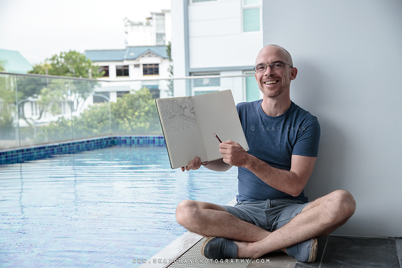 Artist sketching photoshoot with Jerome Cheze at poolside (One Robey)