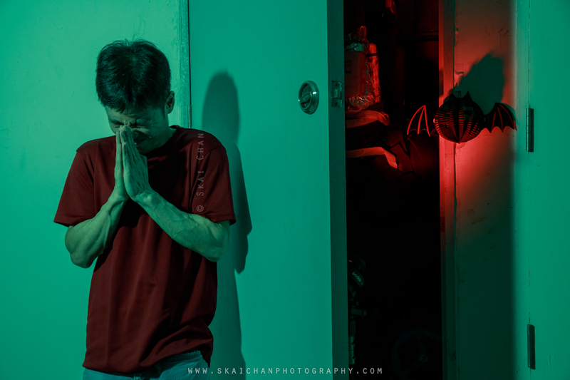 Skai clasping his hands beside the partially opened CCS riser, expressing desperation and a plea for relief