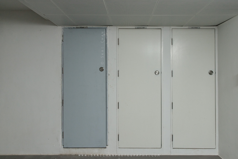 Closed Tengah CCS riser beside electrical and utility cabinet doors in a residential corridor