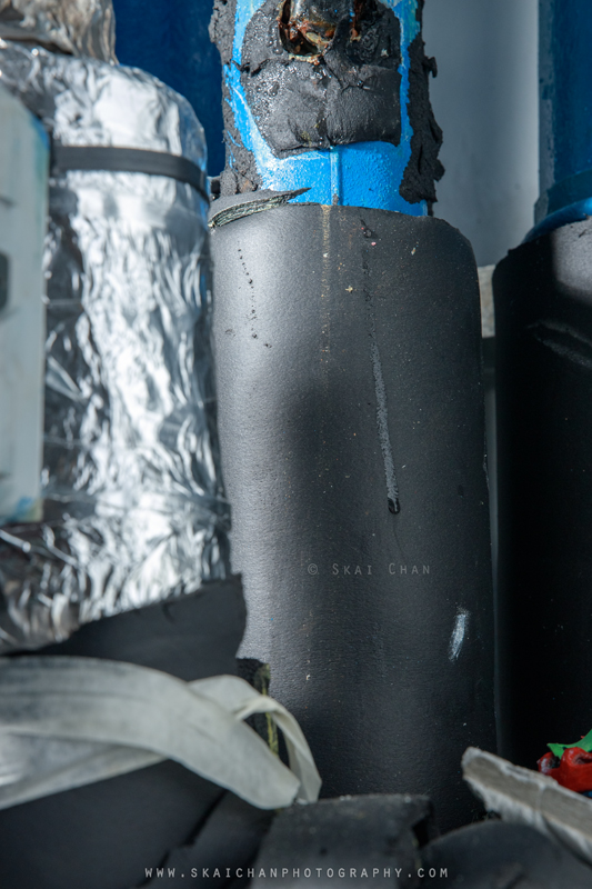Visible moisture trail on black pipe insulation inside the Tengah centralised cooling system riser